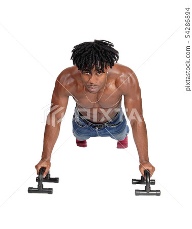 A black man working out with push ups on floor 54286894
