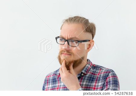 People and negative emotions concept - bearded man in glasses thinking hard about something 54287638