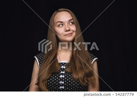 Close up portrait of young woman isolated on black studio background 54287779