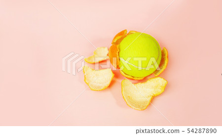 Tennis ball in an orange, concept on tpastel pink background. Tennis ball in an orange, concept on tpastel pink background. 54287890