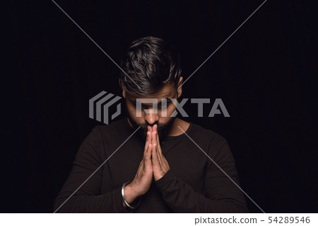 Close up portrait of young man isolated on black studio background 54289546