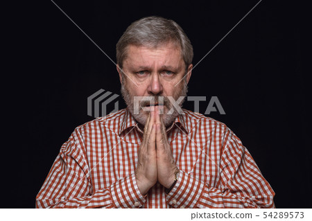 Close up portrait of senior man isolated on black studio background Close up portrait of senior man isolated on black studio background 54289573
