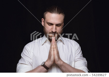 Close up portrait of young man isolated on black studio background 54289627