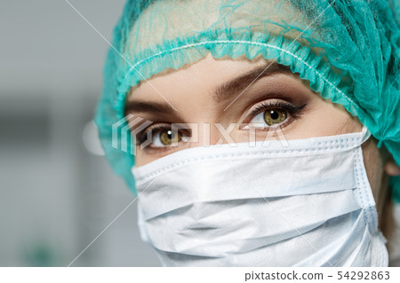 Female doctor's face wearing protective mask Female doctor's face wearing protective mask 54292863