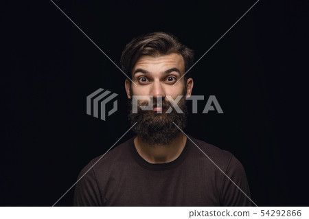 Close up portrait of young man isolated on black studio background Close up portrait of young man isolated on black studio background 54292866