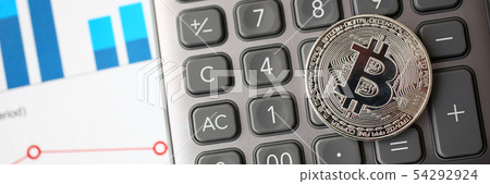 Silver btc sign coin lying at stats graph closeup 54292924