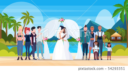 couple newly weds lesbians in white dress standing behind arch same gender married homosexual family 54293351