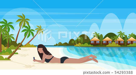 bikini woman sunbathing girl in swimsuit using smartphone social media communication summer vacation 54293388