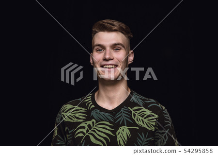 Close up portrait of young man isolated on black studio background Close up portrait of young man isolated on black studio background 54295858