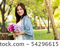 beautiful asian woman with flower in hand 54296615