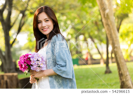 beautiful asian woman with flower in hand 54296615