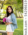 beautiful asian woman with flower in hand 54296619