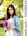 beautiful asian woman with flower in hand 54296620