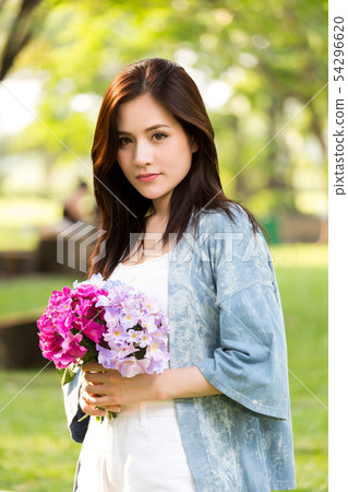 beautiful asian woman with flower in hand beautiful asian woman with flower in hand 54296620