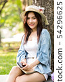 woman smile and hold smartphone in hand 54296625