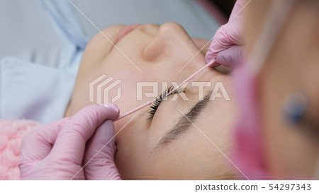 Eyelash Extension Procedure. Woman Eye with Long 54297343