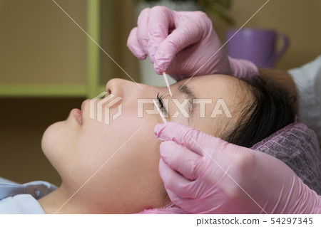 Eyelash Extension Procedure. Woman Eye with Long 54297345