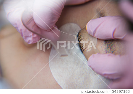 Eyelash Extension Procedure. Woman Eye with Long Eyelash Extension Procedure. Woman Eye with Long 54297363