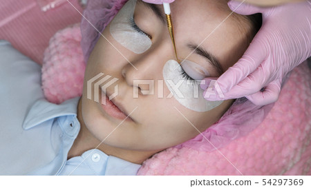 Eyelash Extension Procedure. Woman Eye with Long Eyelash Extension Procedure. Woman Eye with Long 54297369