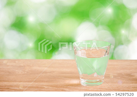 Nature background with a glass of water on the table. Backlight addition version 54297520