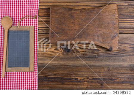 An old slate board together with a wooden spoon An old slate board together with a wooden spoon 54299553