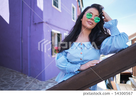 tourist woman posing among colorful houses on 54300567