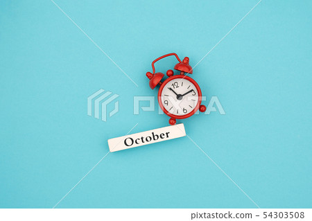 Wooden calendar autumn month October and red alarm 54303508