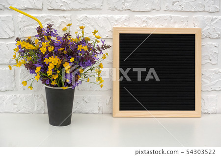 Bouquet of colored flowers in black paper coffee 54303522