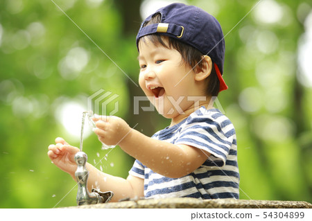 Boy playing with water Boy playing with water 54304899