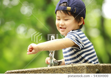 Boy playing with water Boy playing with water 54304900