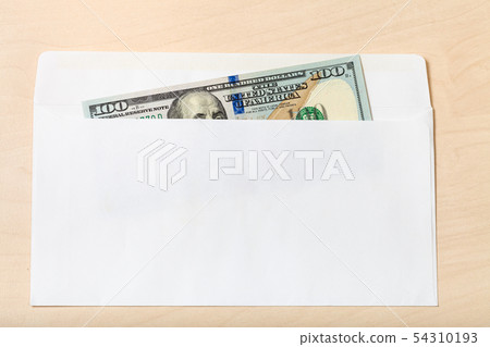 one hundred-dollar bill in open envelope on table 54310193