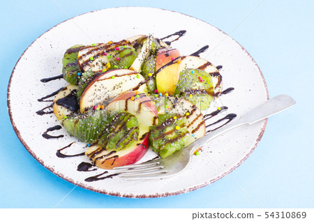 Tasty fruit salad on bright pastel background Tasty fruit salad on bright pastel background 54310869