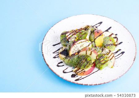 Tasty fruit salad on bright pastel background 54310873