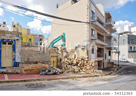 Excavator working at the demolition of an old 54312365