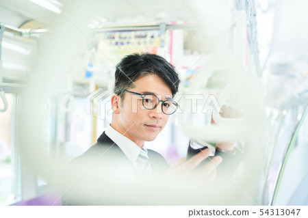 Businessman on a train Businessman on a train 54313047
