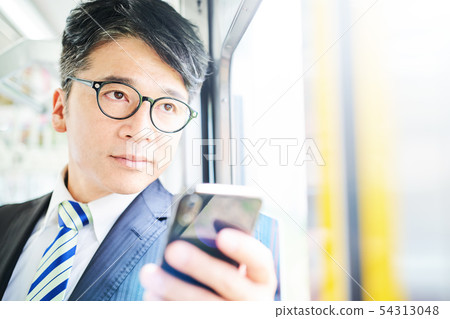 Businessman on a train Businessman on a train 54313048