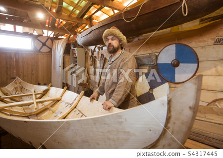 Wooden boat in the barn Wooden boat in the barn 54317445
