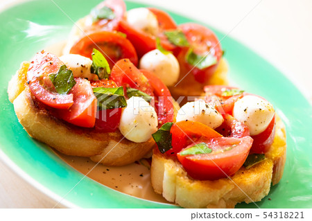 Bruschetta with tomato and mozzarella cheese Bruschetta with tomato and mozzarella cheese 54318221