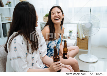 friends in living room relax with electric fan friends in living room relax with electric fan 54318250