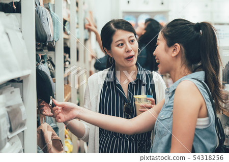 asian women talking laughing in shop asian women talking laughing in shop 54318256