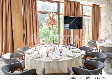 Wedding Banquet or gala dinner. The chairs and table for guests, served with cutlery and crockery Wedding Banquet or gala dinner. The chairs and table for guests, served with cutlery and crockery 54319004