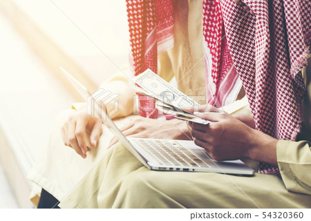 Handsome greedy arab man showing money on hands 54320360
