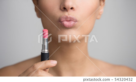 Lady Holding Pink Lipstick and Sending Air Kiss 54320432