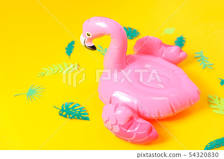 Inflatable pink flamingos on a bright yellow Inflatable pink flamingos on a bright yellow 54320830