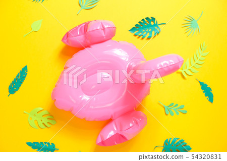 Inflatable pink flamingos on a bright yellow Inflatable pink flamingos on a bright yellow 54320831