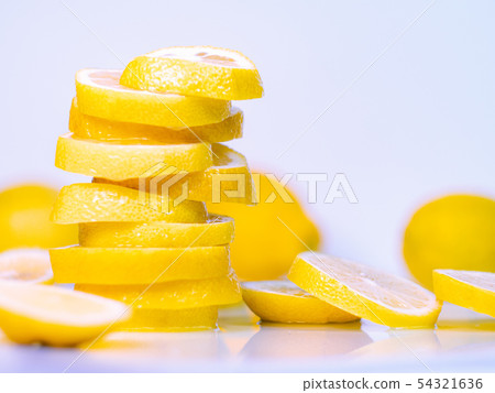 Freshly cutted lemons on light background, close Freshly cutted lemons on light background, close 54321636
