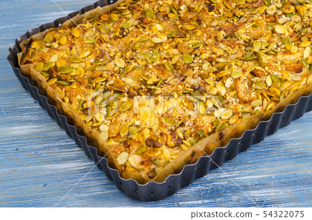 Apple tart with pumpkin seeds. Apple tart with pumpkin seeds. 54322075