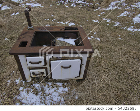 An old wood stove in the open on a meadow An old wood stove in the open on a meadow 54322683