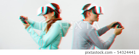 Man and woman with virtual reality headset are playing game. Image with glitch effect. 54324441