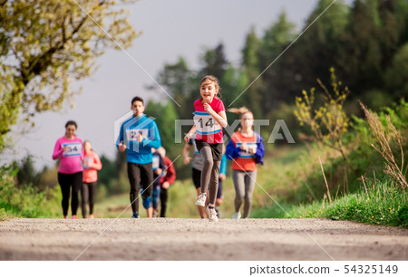 Large group of multi generation people running a race competition in nature. 54325149